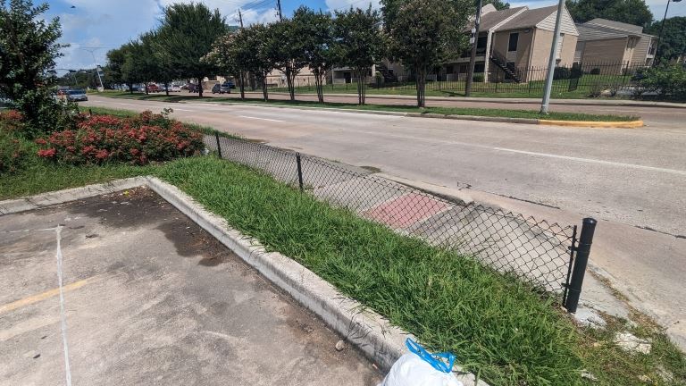 Litter has been cleaned near the base of the fence