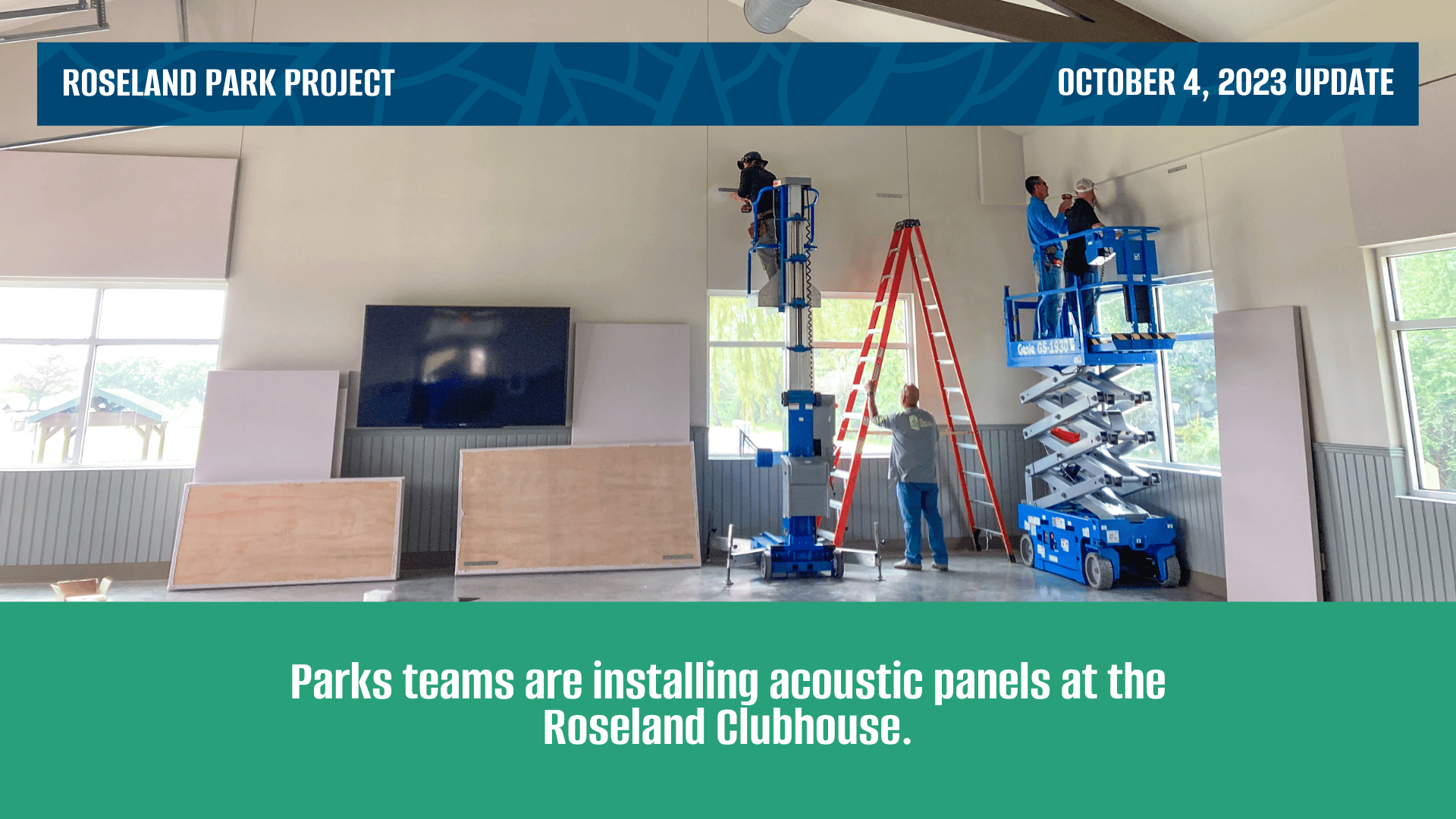 Workers with tools standing on ladders installing acoustic paneling.